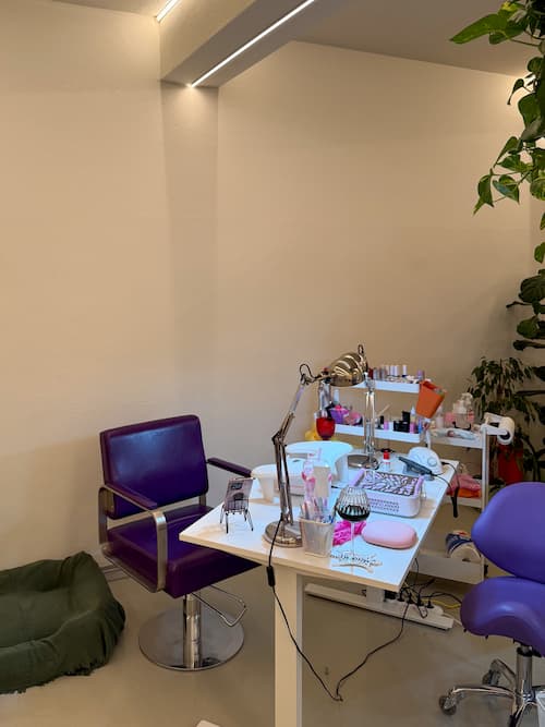 Manicure station with purple chairs and nail tools at Brama Hair Studio
